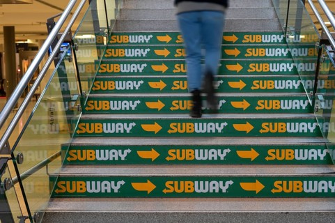 Advertising for a fast food restaurant on the stairs at the main railway station, Nuremberg, Middle