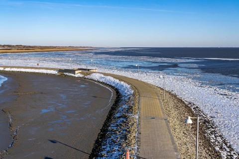 The East Frisian North Sea island of Juist in winter, harbour area, Juist pier, frozen coast facing