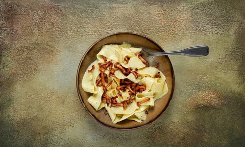Pasta papardelle, in creamy garlic sauce, with mushrooms, traditional Italian cuisine, pasta