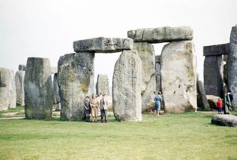 People exploring the standing stones at the Neolithic site of Stonehenge, Wiltshire, England, UK
