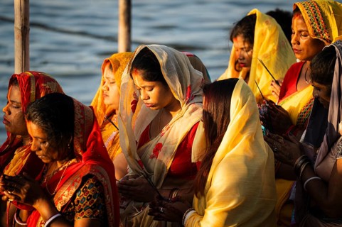 Hindu devotees perform rituals as they offer prayers to the Sun god in the bank of Brahmaputra