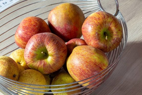 Close-up of apples and pears in the fruit basket