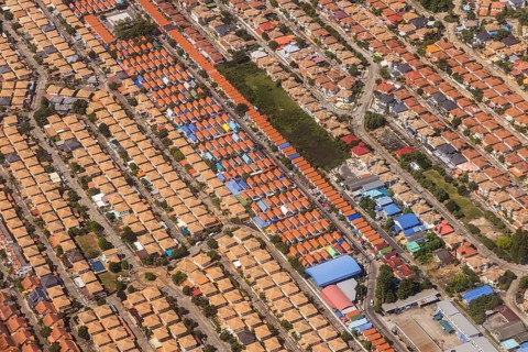 Retort city in the north-east of Bangkok. Standardised houses stand close together on the straight
