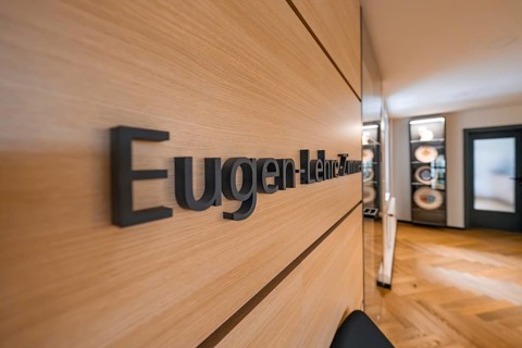 Modern hallway with wooden wall and the lettering 'Lehre-Zimmer', behind it a seating area, Nagold