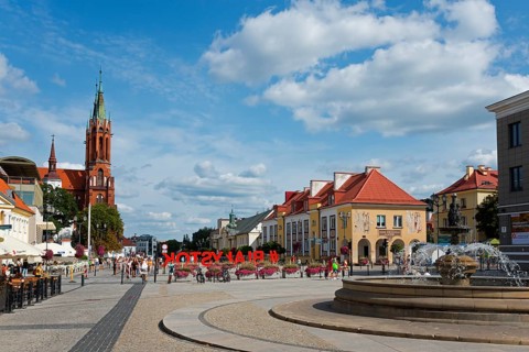 Urban street scene with church, colourful buildings and a fountain, Kosciuszko Market Square,