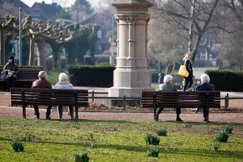 Krefeld, North Rhine-Westphalia, Germany - Senior citizens sitting on a park bench in the district