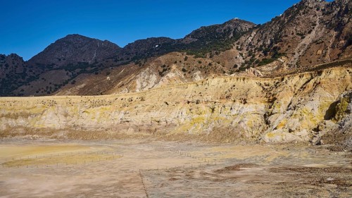 Barren volcanic crater landscape with mountains under a clear blue sky, volcanism, volcanic island,