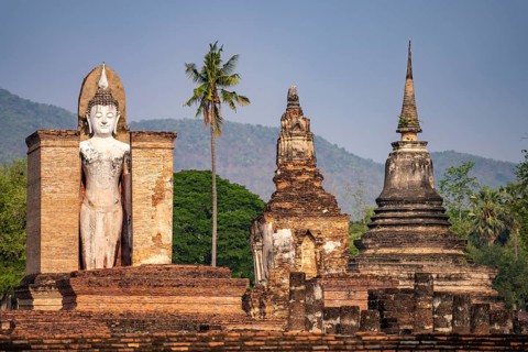 Giant standing Buddha in the Wat Mahathat temple in the UNESCO World Heritage Sukhothai Historical