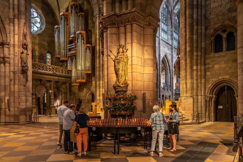 Madonna and sacrificial candles in the interior of Freiburg Minster, Freiburg im Breisgau, Black