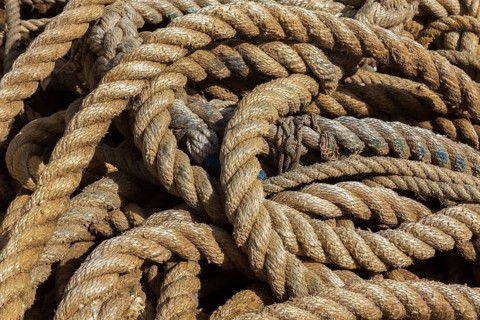 Close-up of old coiled mixed size ropes on the ground, Port of Gruz, Dubrovnik, Croatia, Europe
