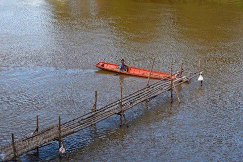 Red boat on a bamboo jetty on the Mekong, Luang Prabang, Laos, Asia