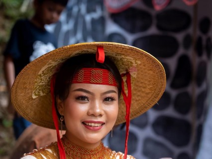 Toraja woman in traditional colourful clothes with rice straw hat, smiling, portrait, Tana Toraja,