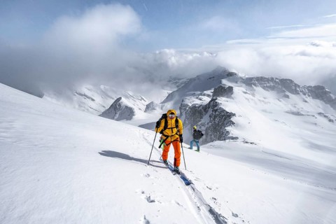 Ski tourers climbing the Wildhorn, Snowy mountain landscape and fog, Bernese Alps, Bernese