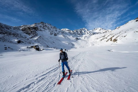 Ski tourers in Val Martello, snow-covered mountain landscape, Monte Cevedale mountain peak in the