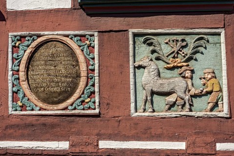 Colourful painted carvings, medallion with inscription, relief for blacksmith Johenrich Jung on the