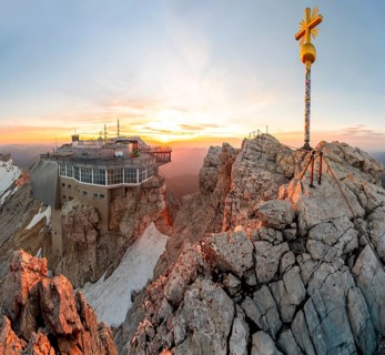 Summit of the Zugspitze with golden summit cross and mountain station of the Bavarian Zugspitze,