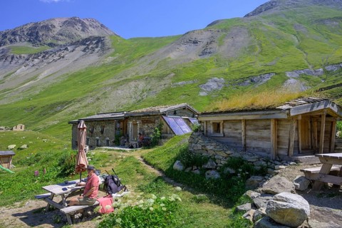 Woman enjoying a coffee break at the Chalet refuge de Chamoissiére, Villar-d'Arêne, Département