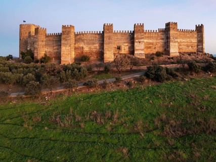 The impressive Moorish Burgalimar castle at the town of Baños de la Encina. Drone shot. Jaén