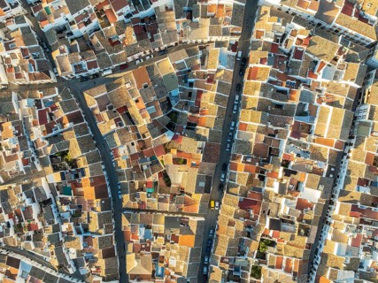 Streets and rooftops in the White Town of Olvera. Aerial view. Drone shot. Cádiz province,
