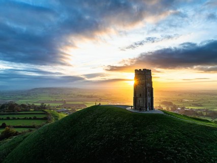 Sunrise over Glastonbury Tor from a drone at autumn, Glastonbury, Somerset, England, United
