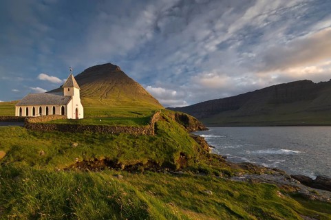 Church in the evening light surrounded by mountains, sea, Vidareidi, Vidoy Island, Viðareiði, Viðoy
