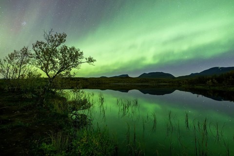 Northern lights reflected in lake, Lapporten, Abisko National Park, Lapland, Sweden, Europe