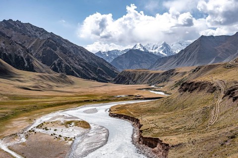 Mountain river in a valley, picturesque mountain landscape with white mountain peaks, Tian Shan