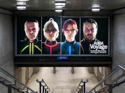 Electronic advertising poster hologram faces pop group Abba promoting Abba Voyage concert, London,