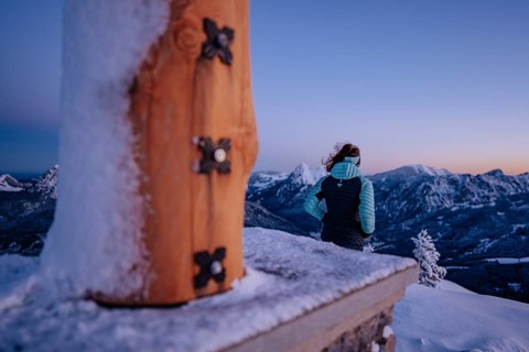Summit bliss in the snow-covered winter landscape in the Tannheimer Tal in the Alps on the