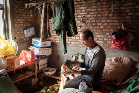 Worker Yang Zhao Bin at his sleeping place, the workers live in the respective buildings where the