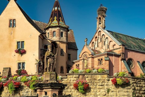 Fountain Fontaine de Saint-Léon and St Leo's Chapel in Eguisheim, Alsace, France, Europe