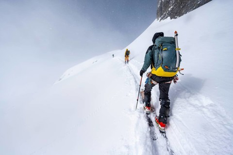 Three ski tourers in a snowy mountain landscape, ascent to the Wildhorn, cloudy mood, high tour,