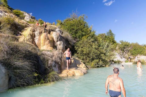 Bathers in one of the thermal pools between the cascades in the limestone on the steep slope of the