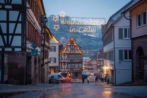 Christmas-lit street with half-timbered houses and wintry backdrop, Calw Christmas market, Black