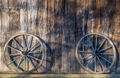 Two wagon wheels leaning against a barn wall, Düstermühle, Legden, district of Wehr, Münsterland,