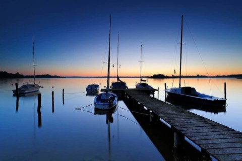 Dawn on the Schaalsee, wooden jetty with sailing boats, Schaalsee Biosphere Reserve,