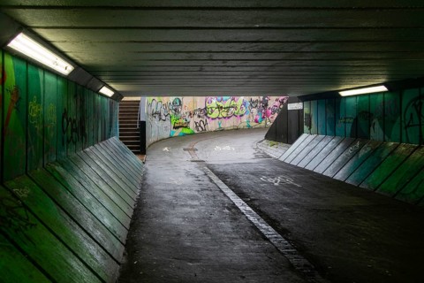 Graffiti paint sprayed tags on walls of Crescent Bridge Subway east underpass in city centre,