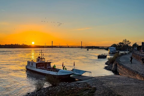 Sunset over the river Rhine Lower Rhine, on the left in the foreground small passenger ferry