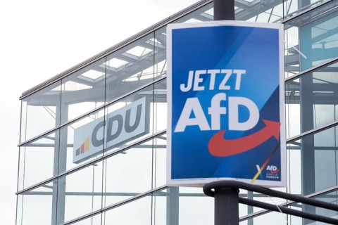 An election poster of the far-right AfD party (now AfD) hangs in front of the CDU logo in front of