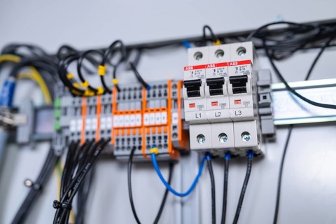 Close-up of circuit-breakers and cables in an electrical system, showing precision in the