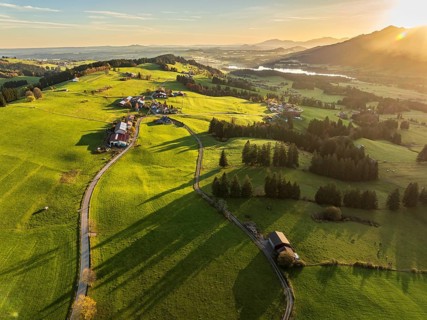 Mountain range near village Wertach, view to lake Gruentensee, sunrise, autumn colors, aerial view,