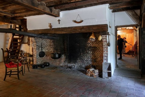 Big hearth, open fireplace in kitchen of 18th century farmhouse Uitschoolhoeve Oevel at open air