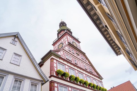 Half-timbered house with soaring church tower and ornate gables, Kirchheim Teck, Germany, Europe