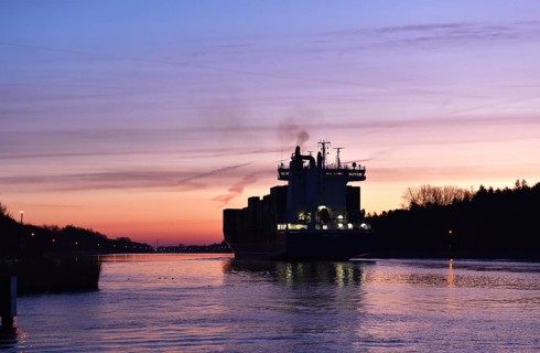 Container ship OOCL RAUMA at the blue hour, sunrise in the Kiel Canal, NOK, Kiel Canal,