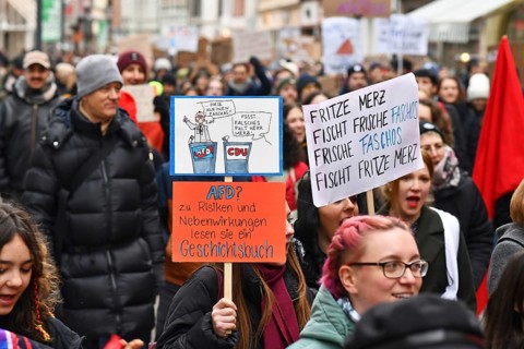 Heidelberg, Germany - February 12th 2025: Crowd of people with signs at protest against far-right