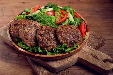 Fried cutlets, mixed minced meat, with vegetable salad, homemade, top view, no people