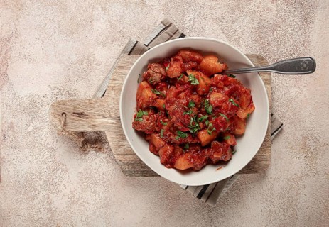 Stew with potatoes and vegetables, in tomato sauce, with spices and herbs, close-up, homemade, no