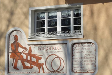 Wall painting with historical tyre cutter and saying in dialect, traditional craft, barrel tyre,