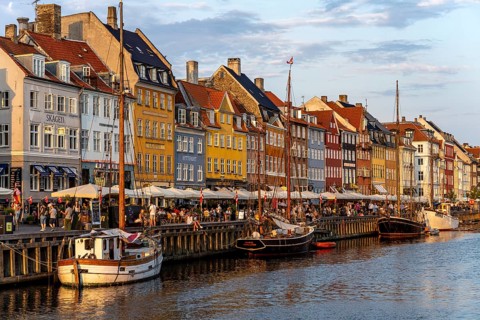 Colourful houses, restaurants and historic ships on the Nyhavn canal and harbour, Copenhagen,