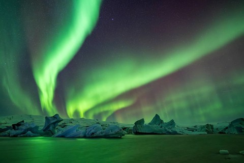 Northern Lights over icebergs in the glacier lagoon, Jökulsarlon, icebergs with glacier,